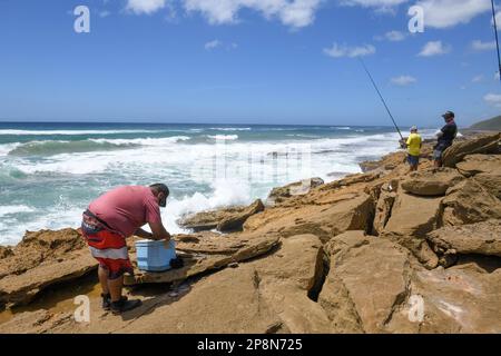 Mission Rocks, South Africa - 14 January 2023: people fishing at Mission Rocks on Isimangaliso park in South Africa Stock Photo