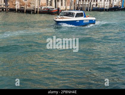 Police boat navigating the grand canal in Venice, Italy Stock Photo