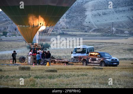 A closeup of a hot air balloon shortly before taking off with ignited burner in Cappadocia, Turkey Stock Photo