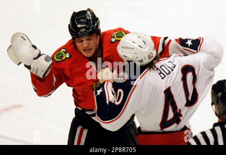 Minnesota Wild's Cal Clutterbuck, left, upends Chicago Blackhawks' Matt  Walker near center ice during the first period of an NHL Hockey game  Sunday, Feb. 22, 2009, in Chicago. (AP Photo/Jim Prisching Stock