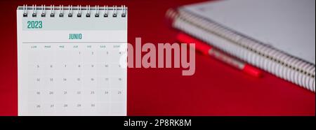 A calendar on a desk with the year 2023 June, red table Stock Photo