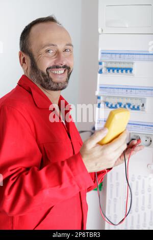 electrician installing energy saving meter Stock Photo