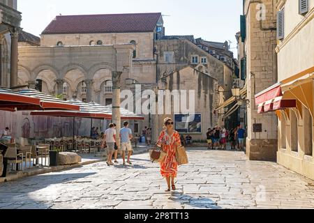 Tourists visiting the Roman Diocletian's Palace ruins in the stari grad / Old Town of the city Split, Split-Dalmatia County, Croatia Stock Photo