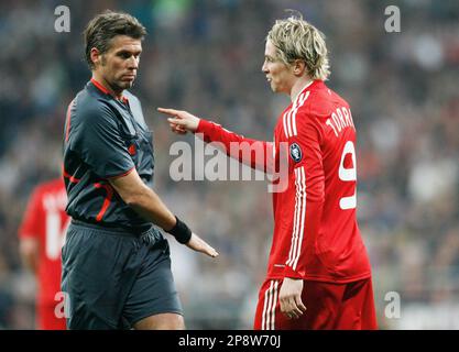 Liverpool's Fernando Torres, right, heads the ball past Real Madrid 's  Pepe, of Brazil, during a Champions League, Round of 16, first leg soccer  match against Real Madrid at the Santiago Bernabeu