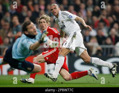 Liverpool's Fernando Torres, right, heads the ball past Real Madrid 's  Pepe, of Brazil, during a Champions League, Round of 16, first leg soccer  match against Real Madrid at the Santiago Bernabeu