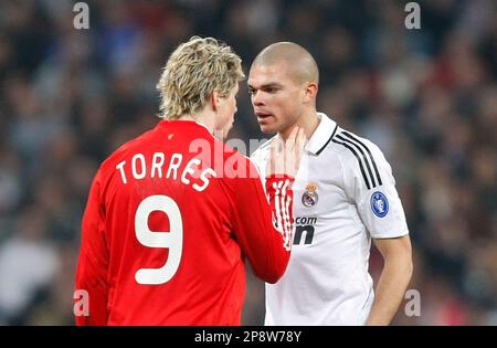Liverpool's Fernando Torres, right, heads the ball past Real Madrid 's  Pepe, of Brazil, during a Champions League, Round of 16, first leg soccer  match against Real Madrid at the Santiago Bernabeu