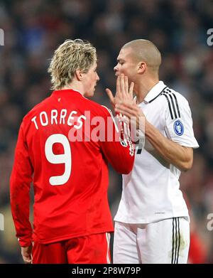 Liverpool's Fernando Torres, right, heads the ball past Real Madrid 's  Pepe, of Brazil, during a Champions League, Round of 16, first leg soccer  match against Real Madrid at the Santiago Bernabeu