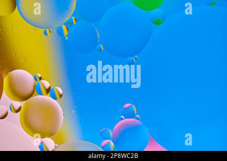 Bright abstract, multicolored background with oil circles.With blue, yellow, pink and green color. Stock Photo