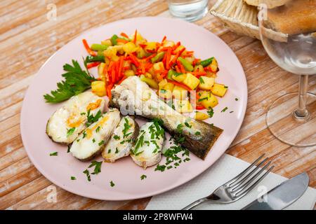 Oven baked hake with vegetable garnish Stock Photo