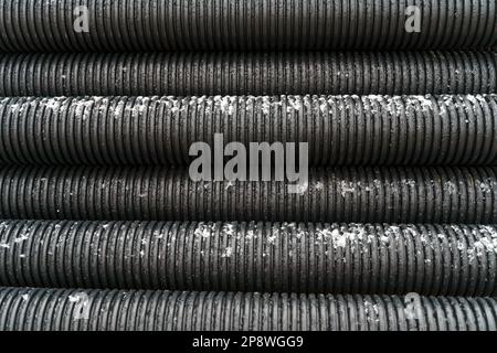Texture of black corrugated pipes. Industrial backgrounds and textures. Stock Photo