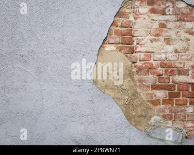 Plaster peeling from an old red brick wall. Stock Photo