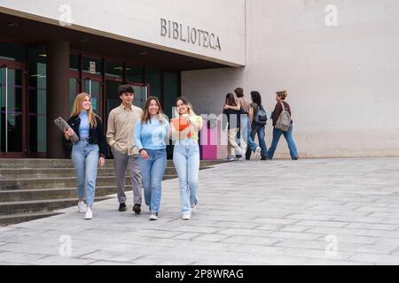 Group of university students leaving the library to prepare for final exams. Concept: Study, University career, higher studies Stock Photo