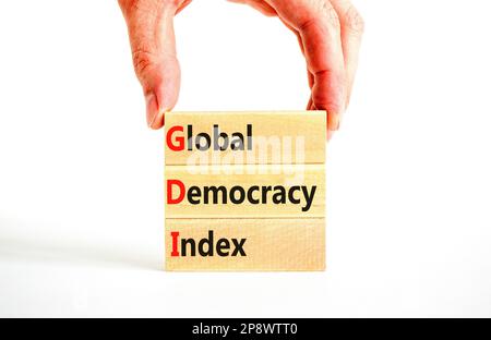 GDI global democracy index symbol. Concept words GDI global democracy index on wooden blocks on a beautiful white table white background. Business and Stock Photo