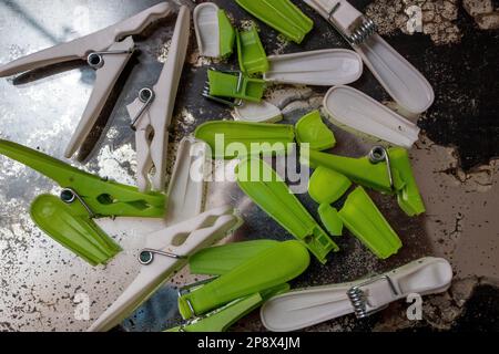 Broken pieces of cheap plastic clothes pegs on an old mirror with much of the silvering Stock Photo