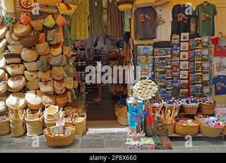 SOLLER, MALLORCA, SPAIN - JUNE 21, 2022: Shop Display Wicker Baskets and bags T-Shirts and books. Stock Photo