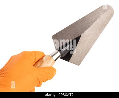 Hand Holding a Trowel isolated on White Background. Construction industry. Copy space Stock Photo