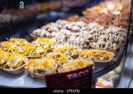 Showcase with various prepared food dishes to consume such as tapas and sandwiches, San Miguel Market, Madrid. Stock Photo