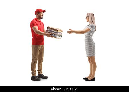 Man delivering a pile of folded clothes to a young woman isolated on a white background Stock Photo