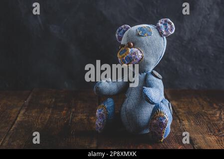 Handmade Teddy Bear Sitting on Wooden Table Stock Photo