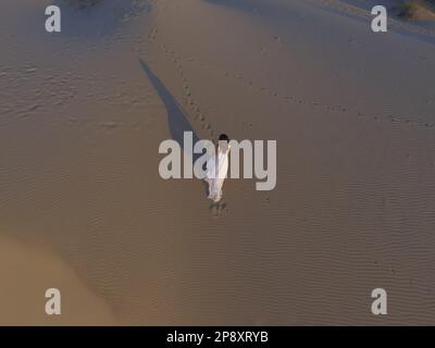 Sandy Dune with woman aerial view Stock Photo