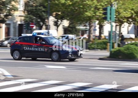 The carabinieri responding to an emergency call out in their Alfa Romeo Giulietta at speed driving through the streets of the Italian port of Trieste. Stock Photo