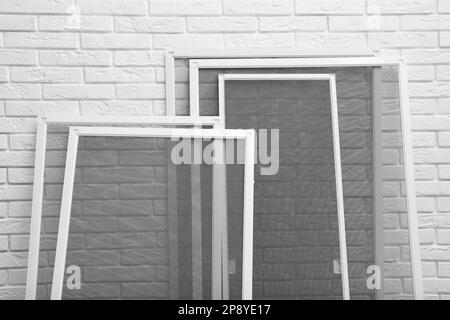 Window Screen Set Designs Set of window screens near white brick wall Stock Photo - Alamy