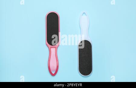 Foot files on light blue background, flat lay. Pedicure tools Stock Photo