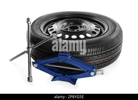 Car wheel, scissor jack and cross torque wrench on white background Stock Photo