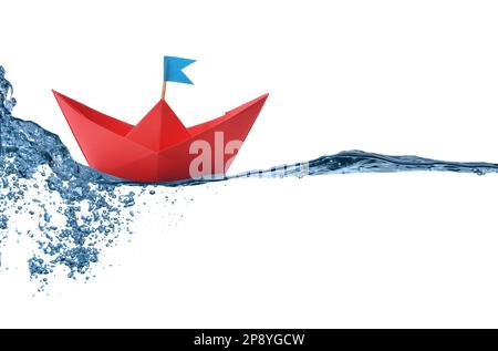 Handmade red paper boat floating on clear water against white background Stock Photo