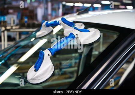 Suction pads for car windshield installing in workshop Stock Photo