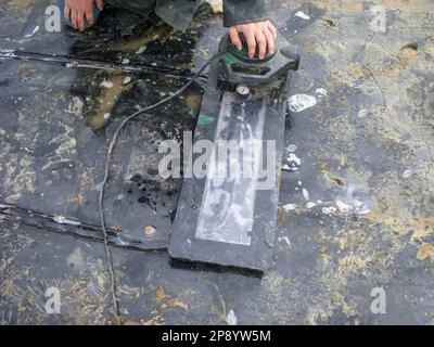 HDPE landfill liner patch installed on a bad weld seam being vacuum tested for leaks. Stock Photo