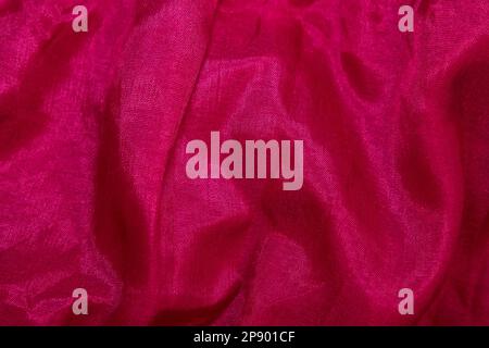 Pink fabric background. Pink cloth waves background texture. Pink fabric cloth textile material. Stock Photo