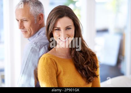 They have each others back. a mature man and his younger wife enjoying time at at home. Stock Photo