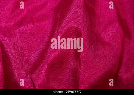 Pink fabric background. Pink cloth waves background texture. Pink fabric cloth textile material. Stock Photo