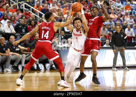 GREENSBORO, NC - MARCH 09: Chase Hunter (1) of the Clemson Tigers defends Jack  Clark (5) of the North Carolina State Wolfpack as he drives to the basket  during the ACC Tournament