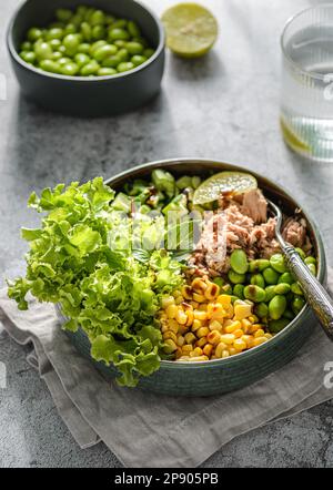 salad bowl with tuna, green beans, corn and cucumber with balsamic sauce. Stock Photo