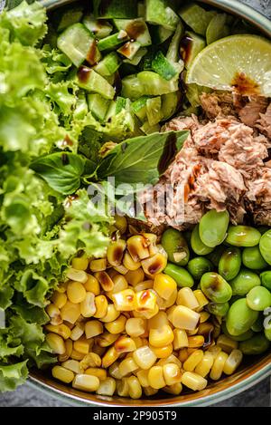 salad bowl with tuna, green beans, corn and cucumber with balsamic sauce. Stock Photo