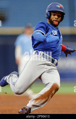 Toronto Blue Jays second baseman Davis Schneider (11) steams third base in the top of the ninth inning during an MLB spring training game against the Stock Photo