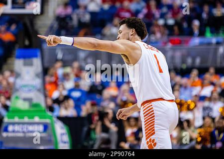 GREENSBORO, NC - MARCH 09: Chase Hunter (1) of the Clemson Tigers defends Jack  Clark (5) of the North Carolina State Wolfpack as he drives to the basket  during the ACC Tournament