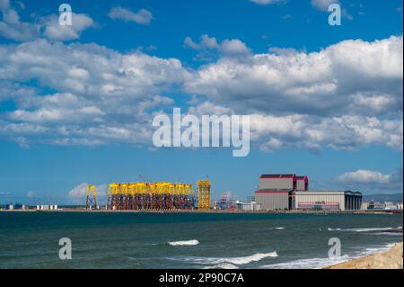 Factory buildings by the sea, blue sky and white clouds moving fast. Pay attention to climate change and industrial development. Taiwan Stock Photo