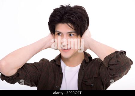 Young man hand cover ear Stock Photo