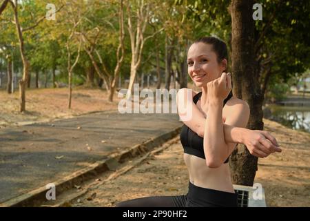 Motivated sporty woman warming up before morning workout. Fitness, sport and healthy lifestyle concept Stock Photo