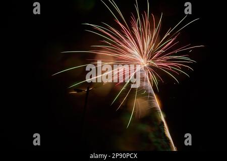 Spectacular multicolored burst of fireworks against the dark sky. Stock Photo