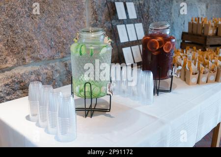 Lemonade with lime slices in glass jars on the table Stock Photo