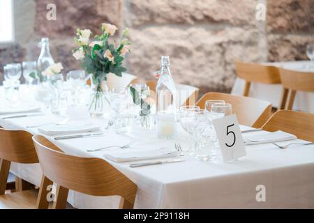 wedding table decoration with flowers and cutlery on table Stock Photo
