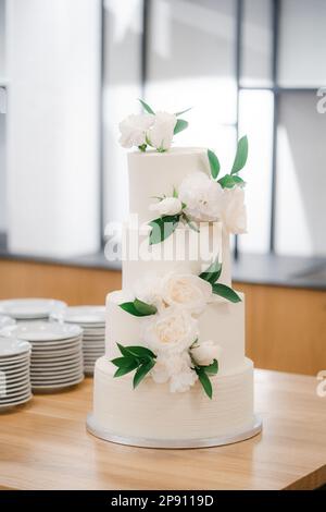 Beautiful big elegant wedding cake with white flowers Stock Photo
