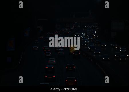 A nocturnal view of traffic travelling along the M3 motorway between junctions 3 and 4 in Surrey Stock Photo
