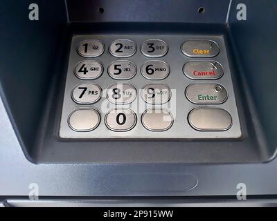 Close up the atm machine number buttons for money withdraw with indonesian money rupiah Stock Photo