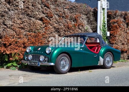 Plougasnou, France - July 17 2021: The Triumph TR3 is a British sports car produced between 1955 and 1962 by the Standard-Triumph Motor Company of Cov Stock Photo