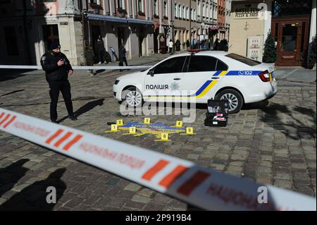 Lviv, Ukraine 10 march 2023. Policeman, car and Ukraines map seen during street action 'Who will punish the criminal?' in Lviv Ukraine. The goal: to draw the world's attention to the fact that the Russian occupiers must answer by name for the crimes they commit in Ukraine. Stock Photo
